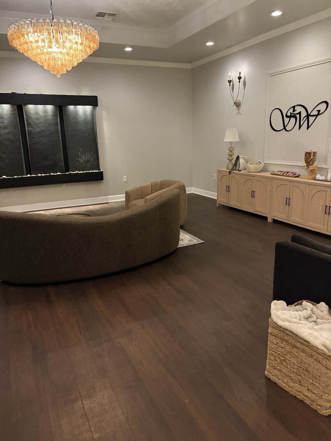 The Stillwater lobby — chandelier, walnut floor, cream walls