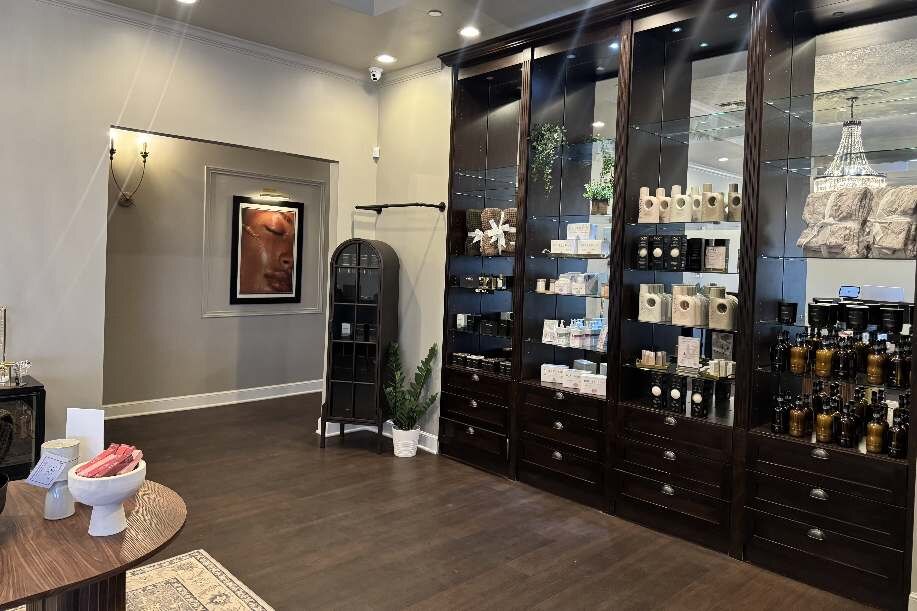 Apothecary retail wall — dark walnut cabinets, product display